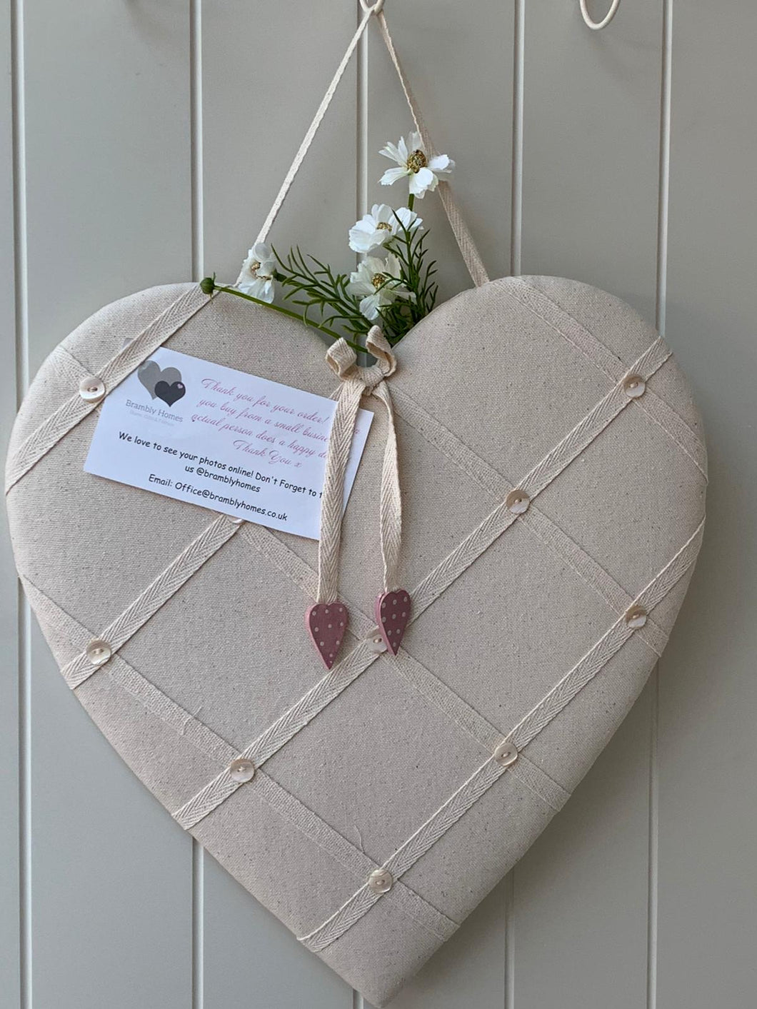 Neutral message board with pink spot hearts